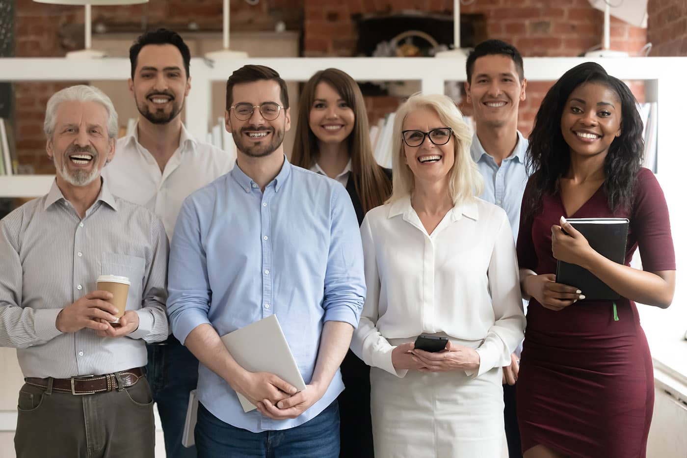 A diverse group of HR professionals smiling at the camera.