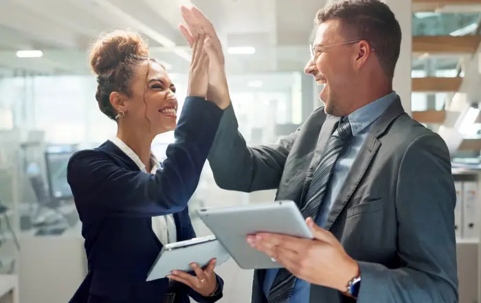 Tablet, team and business people high five for celebration, success and promotion in office. Technology, collaboration and excited professional winning bonus, good news and goal achievement together